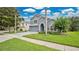 Charming two-story home with a well-manicured lawn, beautiful landscaping, and a blue front door at 2658 Adele Pl, Lake Mary, FL 32746