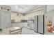 Bright kitchen with white appliances, white cabinetry, tile floors, and updated fixtures at 2658 Adele Pl, Lake Mary, FL 32746