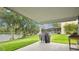 Outdoor patio area with a grill, views of the lake, and lush landscaping at 2658 Adele Pl, Lake Mary, FL 32746