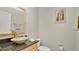 Stylish powder room featuring a decorative vessel sink and granite countertop at 2658 Adele Pl, Lake Mary, FL 32746