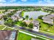 Aerial view of home with lush green lawn and serene water view in a desirable community at 2710 Gorst Rd, Winter Garden, FL 34787