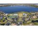 Aerial view showcasing community amenities, including a pool, tennis courts, and lake access at 2710 Gorst Rd, Winter Garden, FL 34787