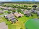 Aerial view of home with lush green lawn, water view, and screened in pool at 2710 Gorst Rd, Winter Garden, FL 34787