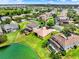 Aerial view of home with lush green lawn and serene water view, and screened in pools at 2710 Gorst Rd, Winter Garden, FL 34787