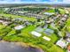 Aerial view showcases the community layout with homes, golf course, and amenities at 2710 Gorst Rd, Winter Garden, FL 34787