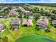 Aerial view of home with lush green lawn and serene water view, with screened in pools at 2710 Gorst Rd, Winter Garden, FL 34787