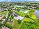 Aerial view of community amenities including tennis courts, pool, lake, and playground at 2710 Gorst Rd, Winter Garden, FL 34787
