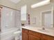 Bright bathroom features a shower-tub combination, vanity, sink, and a large mirror at 2710 Gorst Rd, Winter Garden, FL 34787