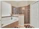 Bright bathroom features a walk-in shower, soaking tub, and a linen closet at 2710 Gorst Rd, Winter Garden, FL 34787