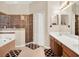 Well-lit bathroom features a walk-in shower, soaking tub, dual sinks, and a walk-in closet at 2710 Gorst Rd, Winter Garden, FL 34787