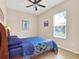 Cozy bedroom with a patterned comforter, a ceiling fan, and a window for natural light at 2710 Gorst Rd, Winter Garden, FL 34787