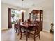 Formal dining room with a wooden table set, china cabinet, and natural light from a large window at 2710 Gorst Rd, Winter Garden, FL 34787