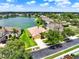 Aerial view of a beautiful home with lush landscaping and a serene lake in the background at 2710 Gorst Rd, Winter Garden, FL 34787