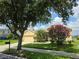 Inviting single-story home with a well-manicured lawn and vibrant flowering shrubs in a tranquil setting at 2710 Gorst Rd, Winter Garden, FL 34787