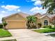 Charming home with a well-manicured lawn, vibrant flowers, and a two-car garage at 2710 Gorst Rd, Winter Garden, FL 34787