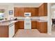 Well-equipped kitchen featuring wood cabinets and ample counter space, complete with modern appliances at 2710 Gorst Rd, Winter Garden, FL 34787