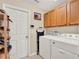 Bright laundry room with white washer, dryer, cabinets, and convenient storage solutions at 2710 Gorst Rd, Winter Garden, FL 34787