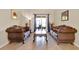Comfortable living room featuring tile floors, plush seating, and access to outdoor patio at 2710 Gorst Rd, Winter Garden, FL 34787