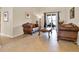 Cozy living room with tile flooring, plush seating, and sliding glass doors to a patio at 2710 Gorst Rd, Winter Garden, FL 34787