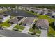 Aerial view of new homes in a Primary-planned community with a large pond at 284 White Heron Way, St Cloud, FL 34772