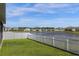 Spacious backyard with white fence and a pond in the neighborhood at 284 White Heron Way, St Cloud, FL 34772