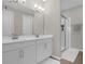 Bathroom featuring dual sinks, spacious vanity, and glass-enclosed shower with white tile at 284 White Heron Way, St Cloud, FL 34772