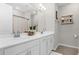 Bright bathroom features a double vanity with white cabinets, modern fixtures, and decorative shelving at 284 White Heron Way, St Cloud, FL 34772