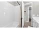 Bathroom with tile surround, shower curtain, and open door showing view to next room at 284 White Heron Way, St Cloud, FL 34772