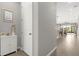 Inviting hallway featuring neutral walls, ceramic tile flooring, and bright natural light throughout the home at 284 White Heron Way, St Cloud, FL 34772