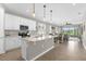 Bright, open kitchen featuring stainless steel appliances, granite countertops, and a view to the living room at 284 White Heron Way, St Cloud, FL 34772