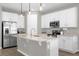 Kitchen featuring stainless steel appliances, white cabinetry, tile floors, and modern pendant lighting at 284 White Heron Way, St Cloud, FL 34772