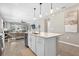 Open-concept living room and kitchen featuring modern finishes and ample natural light from the sliding glass door at 284 White Heron Way, St Cloud, FL 34772