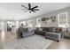 Inviting living room featuring a comfortable gray couch, stylish decor, and access to the kitchen at 284 White Heron Way, St Cloud, FL 34772