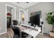Well-lit office space equipped with an adjustable desk, a monitor and tasteful decor at 284 White Heron Way, St Cloud, FL 34772