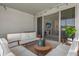 Covered patio with furniture, lighting and view into the living room at 284 White Heron Way, St Cloud, FL 34772