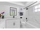 Modern bathroom with a black-framed mirror and shower with white marble-like tiles at 2903 Clear Way, Orlando, FL 32805