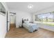 Cozy bedroom with plank walls, hardwood floor, and a large window with neighborhood views at 2903 Clear Way, Orlando, FL 32805