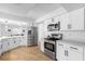 Well-appointed kitchen with stainless steel appliances, white cabinets, and an open layout for easy entertaining at 2903 Clear Way, Orlando, FL 32805