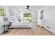 Bright main bedroom with a ceiling fan, wood floors, white walls, and a backyard view at 2903 Clear Way, Orlando, FL 32805