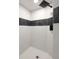 Modern tiled corner shower with white and black patterned tile and black shower head at 2903 Clear Way, Orlando, FL 32805