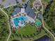 Aerial view of a community pool, splash pad, playground, green space and parking at 2941 Marlberry Ln, Clermont, FL 34714