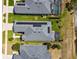 This aerial view shows a well-maintained property, solar panels, and a screened-in pool at 2941 Marlberry Ln, Clermont, FL 34714