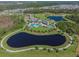 The aerial view features a walking trail around a lake with a playground, and community pool nearby at 2941 Marlberry Ln, Clermont, FL 34714