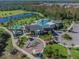 Aerial view of a community center, pool, splash pad, playground, lake and surrounding green space at 2941 Marlberry Ln, Clermont, FL 34714