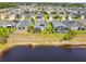 This view displays a well-situated property with a water view and screened-in patio enclosure at 2941 Marlberry Ln, Clermont, FL 34714