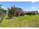 Professionally landscaped backyard showcasing a lush lawn, privacy fence, and a view of the screened lanai at 2941 Marlberry Ln, Clermont, FL 34714