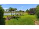Tranquil backyard featuring a lush lawn, landscaping, and serene water view, perfect for outdoor enjoyment and relaxation at 2941 Marlberry Ln, Clermont, FL 34714