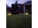 Inviting backyard with screened enclosure and landscape lighting for evening enjoyment at 2941 Marlberry Ln, Clermont, FL 34714