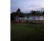 Scenic backyard featuring a serene pond view, complemented by lush landscaping and colorful accents at 2941 Marlberry Ln, Clermont, FL 34714