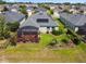 This image shows a backyard featuring a screened-in lanai and landscaped areas, adding outdoor charm at 2941 Marlberry Ln, Clermont, FL 34714